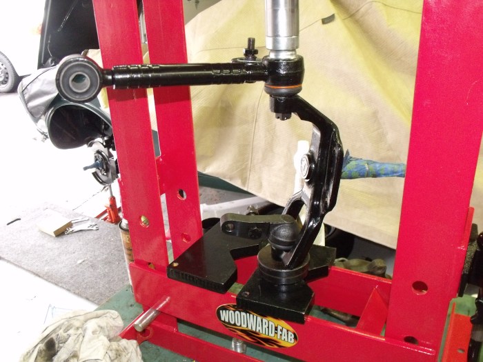 Using the bench-top press to drive home the upper control arm/ball joint into the spindle. 