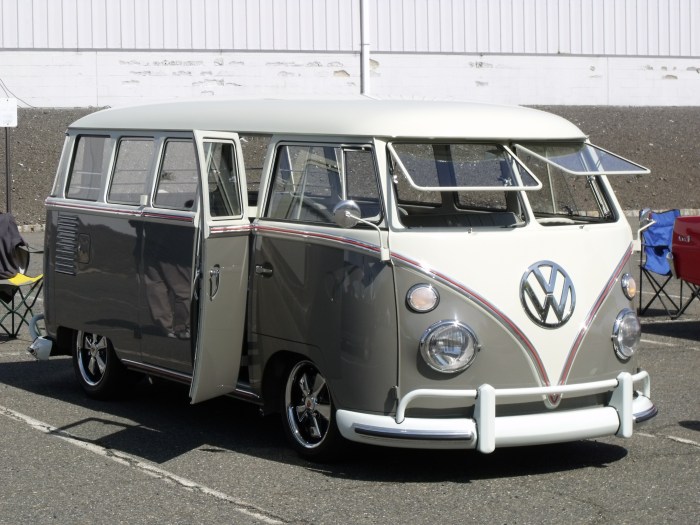 A beautifully restored VW bus, lowered and wearing Porsche wheels. 