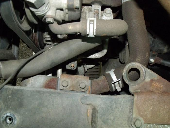 The entire air filter box must be removed to gain access to the lower rear hose (at right)