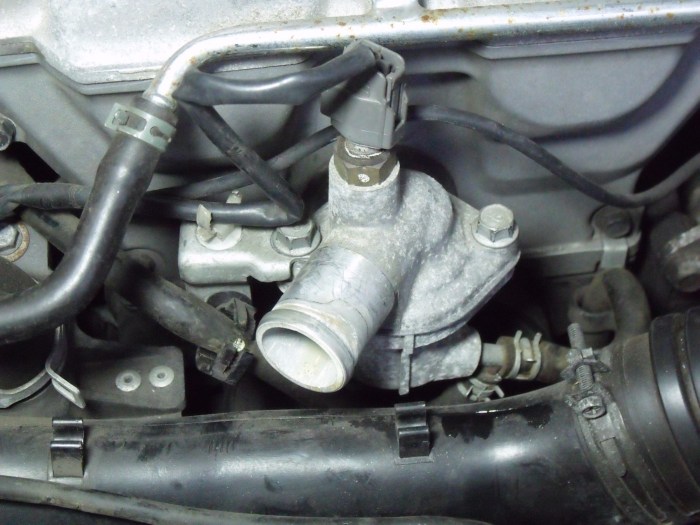 Note clamps under and to the right of thermostat housing